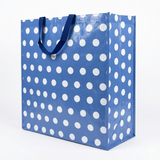Blue tote bag with white polka dots on a white background