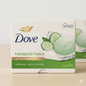 Dove soap packaging with cucumber and green tea elements on a light background