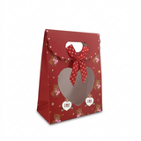 Red gift bag with heart cutout, teddy bears, and 'love' text on a white background
