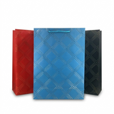 Three patterned gift bags in red, blue, and black on a white background