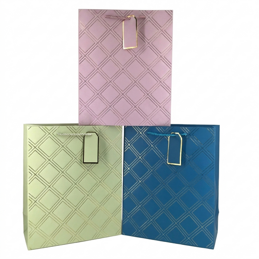 Three patterned gift bags in pink, green, and blue on a white background