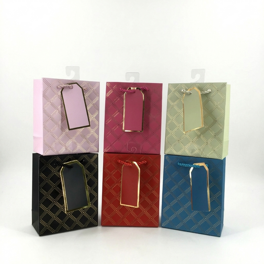 Set of six colorful gift bags with gold tags on a white background