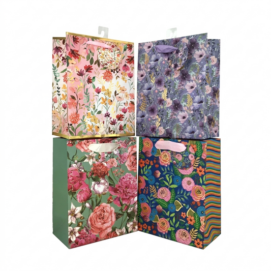Four floral-patterned gift bags in different colors on a white background