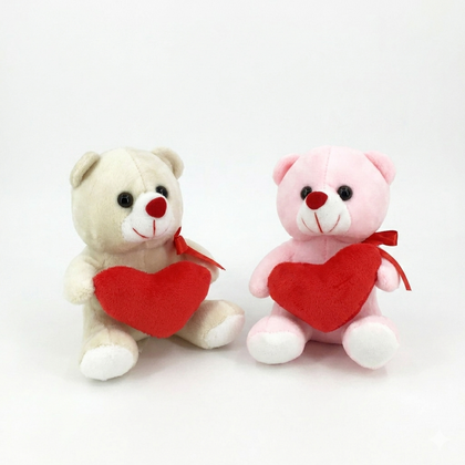 Two teddy bears, one beige and one pink, holding red hearts on a white background.