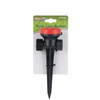 Plastic turret sprinkler with red top on a white background