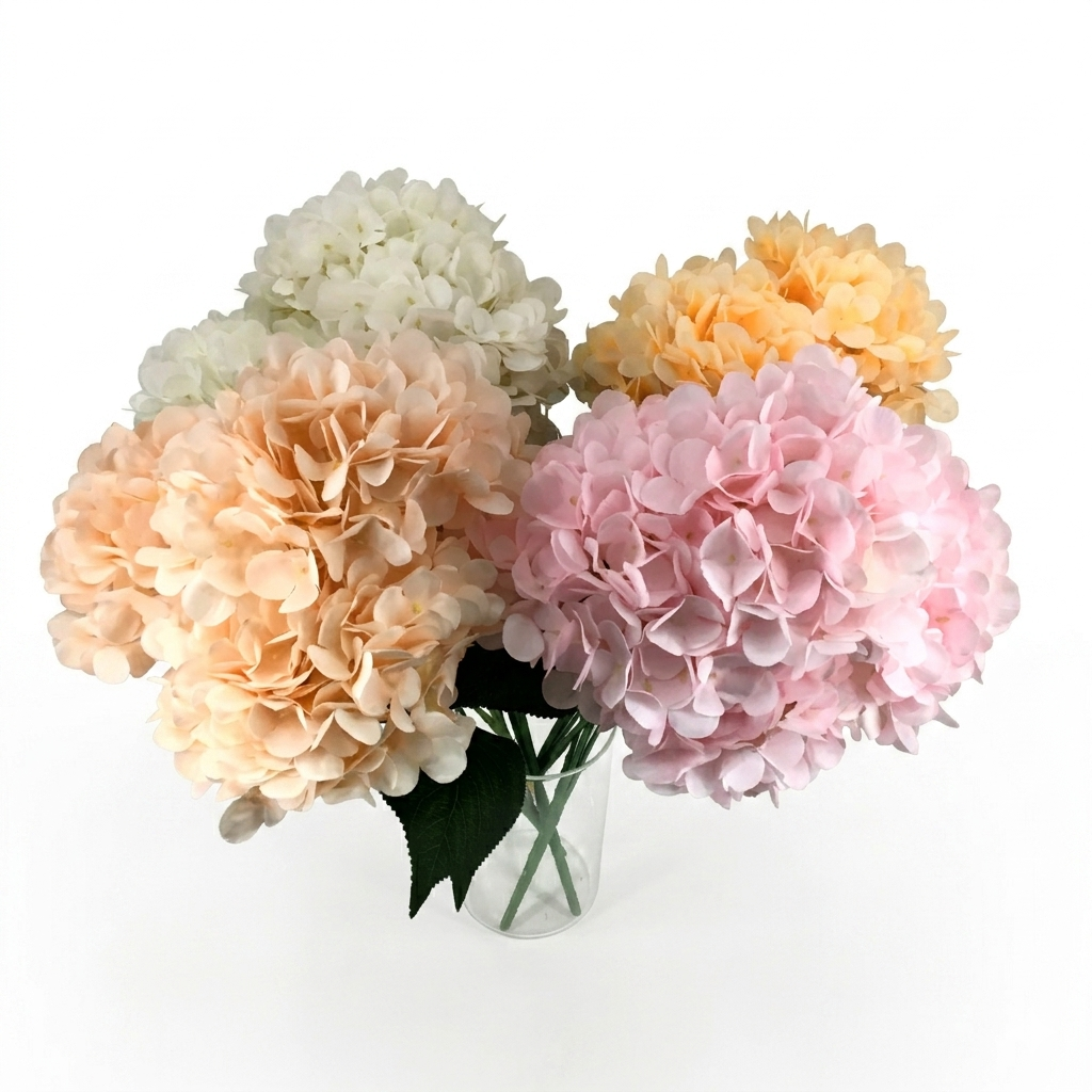 Bouquet of hydrangeas in various colors in a clear vase on a white background
