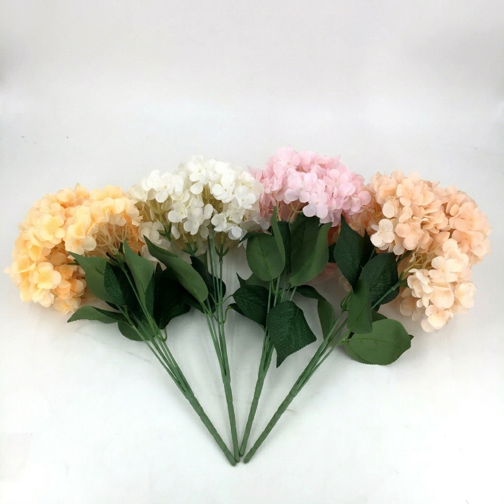 Bouquet of artificial flowers in peach, white, and pink on a white background