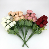 Bouquets of artificial flowers in white, pink, and red on a white background