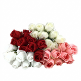Bouquet of red, white, and pink artificial roses on a white background