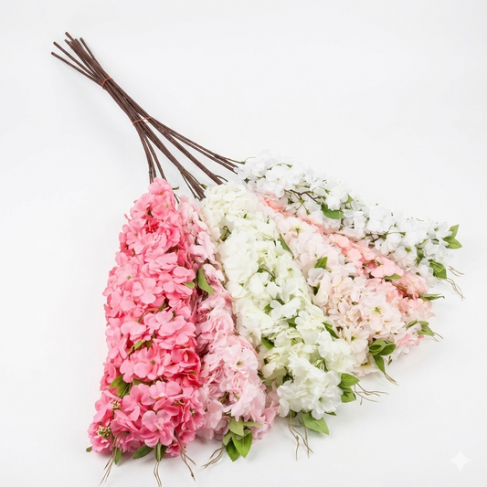 Three bundles of pink and white sakura cherry blossom flowers on a white background
