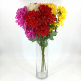 Bouquet of colorful flowers in a clear vase on a white background