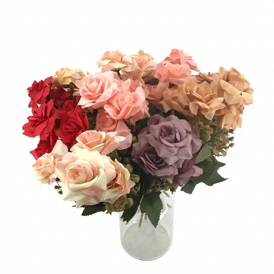 Bouquet of artificial flowers in a clear vase on a white background