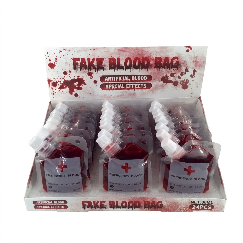 A retail display box containing 24 small fake blood bags labeled 'FAKE BLOOD BAG' and 'ARTIFICIAL BLOOD SPECIAL EFFECTS' with 'EMERGENCY BLOOD' on the front labels.