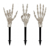 Three plastic skeleton hand garden stakes shown against a plain white background.