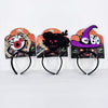Three Halloween headbands displayed side by side on their retail backing cards. The left headband features a skeleton hand holding a large red and black eye.