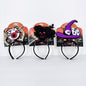 Three Halloween headbands displayed side by side on their retail backing cards. The left headband features a skeleton hand holding a large red and black eye.