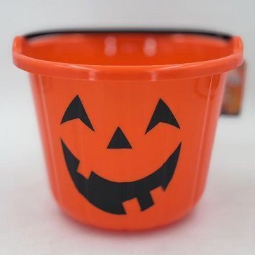 An orange plastic Halloween bucket with a black jack-o'-lantern face printed on the front, set against a plain white background.