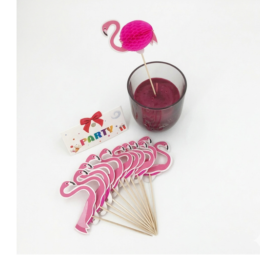 Pink flamingo drink stirrers with a glass of red drink and 'Party' sign on a white background