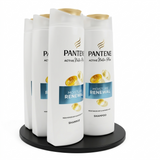 Pantene shampoo bottles on a display stand with a white background
