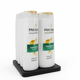 Pantene shampoo bottles on a black stand with a white background