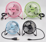 Four small USB fans in pink, green, blue, and black on a white background.
