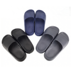 Three pairs of slip-on house slippers shown on a plain white background: one pair in black, one pair in dark gray, and one pair in muted blue.