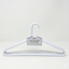 White hanger with a label on a light gray background