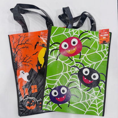 Two Halloween-themed plastic trick or treat bags with black handles, shown on a white background. One bag has an orange haunted house and ghost design, and the other has a green spider web design with three colorful cartoon spiders.
