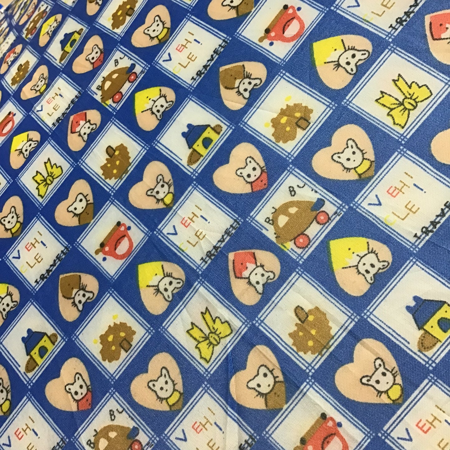 Patterned fabric with cartoon characters and shapes on a blue background