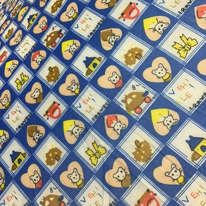 Patterned fabric with cartoon characters and shapes on a blue background