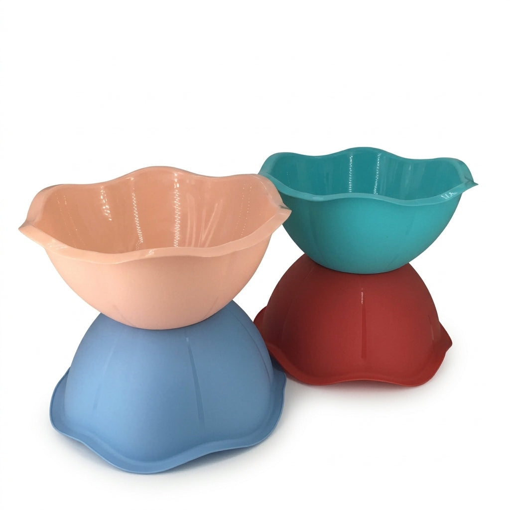 Four flower-shaped plastic mixing bowls stacked in pairs, shown in peach, teal, and red on a white background.