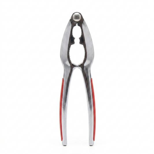 Metallic kitchen Nutcracker with red accents on a white background