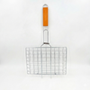 BBQ grill basket with wooden handle in packaging on a white background