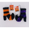 Two fuzzy Halloween stockings shaped like letters M and N, with one stocking in black and orange stripes and the other in black and purple stripes, both with orange 'Halloween Decoration' tags on a white background.