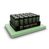 Display of Monster Energy drinks 24 pack on a green platform with a white background